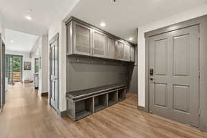 Mudroom featuring light wood-style floors and recessed lighting