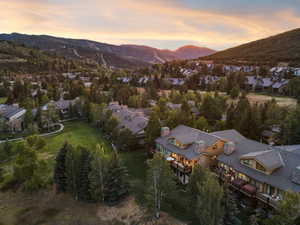 Aerial overview of property's location featuring nearby suburban area and mountains