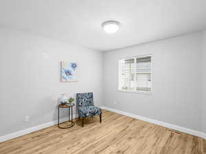 Living area with light wood-style flooring and baseboards