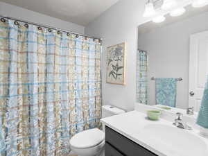 Full bath with vanity and a shower with shower curtain