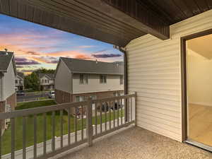Balcony at dusk with a residential view