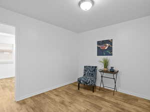 Living area with light wood-style floors and baseboards