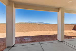 Fenced backyard featuring a patio and a mountain view