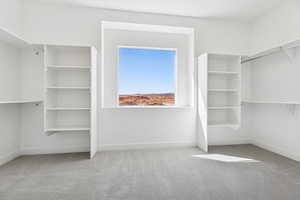 Walk in closet featuring light carpet