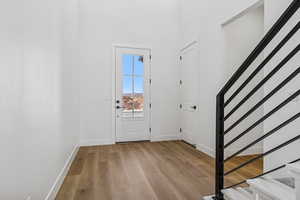 Entryway with stairway and light wood-style flooring