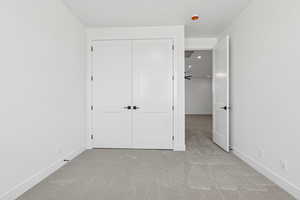 Unfurnished bedroom with carpet floors, recessed lighting, and a closet