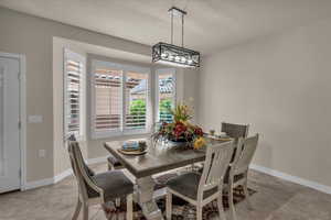 Dining room with light tile patterned floors and baseboards
