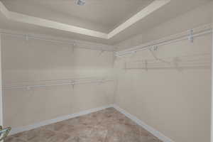 Walk in closet featuring light tile patterned flooring