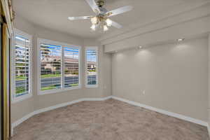Spare room with ceiling fan and light tile patterned floors