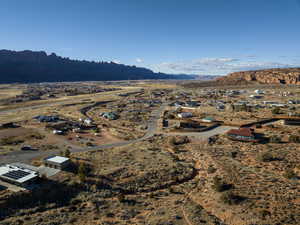 Aerial view of residential area featuring a mountainous background and a desert landscape