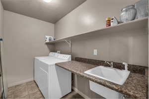 Laundry room featuring baseboards and separate washer and dryer