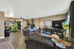 Living area with wood finished floors and ceiling fan