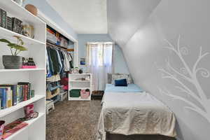 Upstairs bedroom is carpeted and features cool architecture