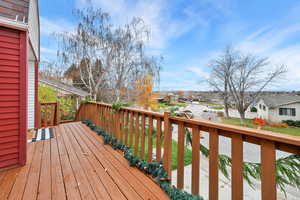 Wooden terrace featuring a residential view