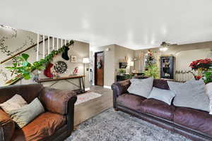 Living room with a ceiling fan and wood finished floors