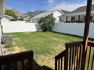 Fenced backyard with a mountain view