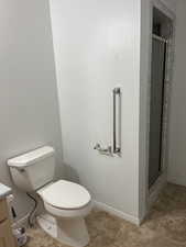 Bathroom featuring a stall shower, vanity, and light tile patterned floors