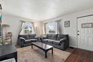 Living area with a textured ceiling and wood finished floors