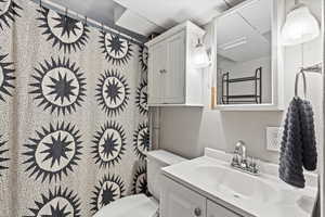 Bathroom with vanity and a textured wall