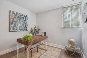 Home office featuring wood finished floors and baseboards