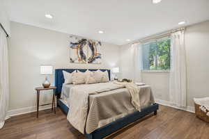 Bedroom with wood finished floors and recessed lighting
