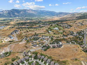 Aerial overview of property's location with a water and mountain view and nearby suburban area