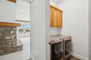 Laundry room with carpet flooring, cabinet space, recessed lighting, and washer and clothes dryer