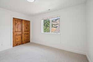 Unfurnished bedroom featuring a closet and carpet flooring
