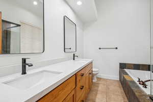 Full bathroom with double vanity, a bath, light tile patterned flooring, recessed lighting, and an enclosed shower
