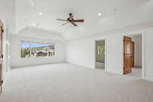 Unfurnished bedroom with light carpet, ceiling fan, recessed lighting, and vaulted ceiling