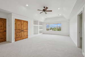 Unfurnished bedroom featuring light carpet, a ceiling fan, a raised ceiling, and recessed lighting