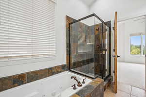 Full bathroom with a shower stall, a whirlpool tub, and tile patterned flooring