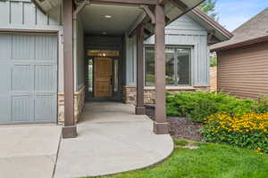 Entrance to property featuring board and batten siding and stone siding