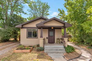 Bungalow-style house with a porch and a vegetable garden