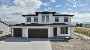View of front of house with a mountain view, driveway, an attached garage, and roof with shingles
