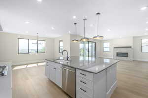 Kitchen with open floor plan, white cabinets, stainless steel appliances, healthy amount of natural light, and recessed lighting