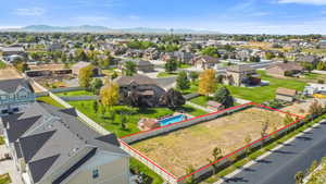 Aerial perspective of suburban area with a mountainous background and property boundaries highlighted