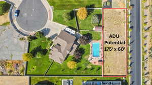 Aerial overview of property's location featuring a pool and property parcel outlined