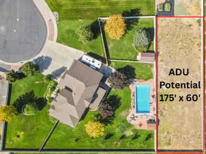 Aerial overview of property's location featuring a pool and property parcel outlined