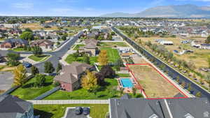 Aerial perspective of suburban area featuring property parcel outlined and a mountainous background