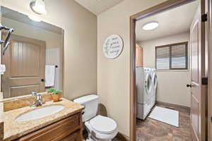 Bathroom featuring vanity and independent washer and dryer