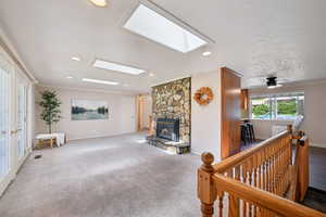 Living area featuring ornamental molding, carpet, a fireplace, recessed lighting, and ceiling fan