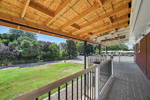 Wooden deck featuring a lawn