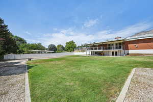 View of yard with a balcony and a patio area