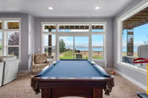 Playroom with carpet flooring, a water view, billiards, a textured ceiling, and recessed lighting
