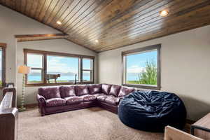 Living room with vaulted ceiling, carpet flooring, wooden ceiling, and recessed lighting