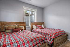 Carpeted bedroom with a textured ceiling