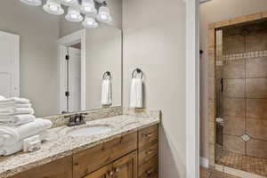 Full bath featuring vanity, a shower stall, and tile patterned floors