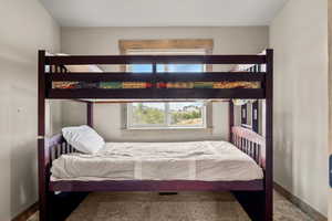 Bedroom with baseboards and carpet