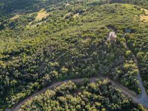 Aerial view of property's location with a forest